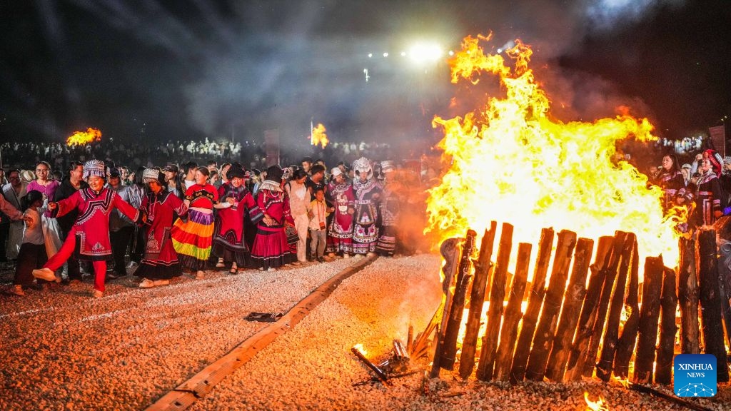 Visitors and local people enjoy themselves around a bonfire in Yi-Hui-Miao Autonomous County of Weining, Bijie, southwest China's Guizhou Province, Aug. 6, 2026. The cool climate and rich tourism resources in Guizhou have attracted lots of visitors seeking a summer retreat. (Photo: Xinhua)