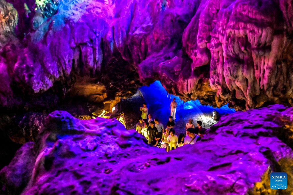 Tourists visit a cave in Guilin, south China's Guangxi Zhuang Autonomous Region, Aug. 12, 2026. In recent years, Guangxi has tapped the tourism potential of its caves, developing them into popular attractions while ensuring visitor safety. (Photo: Xinhua)