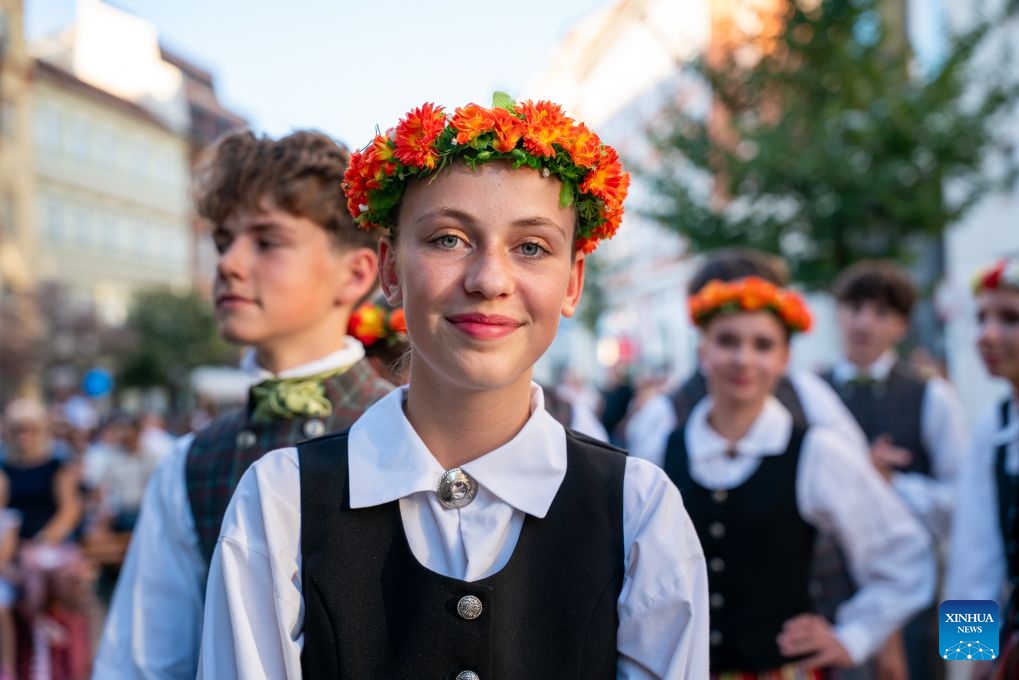 People take part in a parade during the Summer Folklore Festival in Prague, the Czech Republic, Aug. 15, 2026. The Summer Folklore Festival was held in Prague on Saturday, bringing together international folklore ensembles presenting their traditional dances, music and costumes. (Photo: Xinhua)