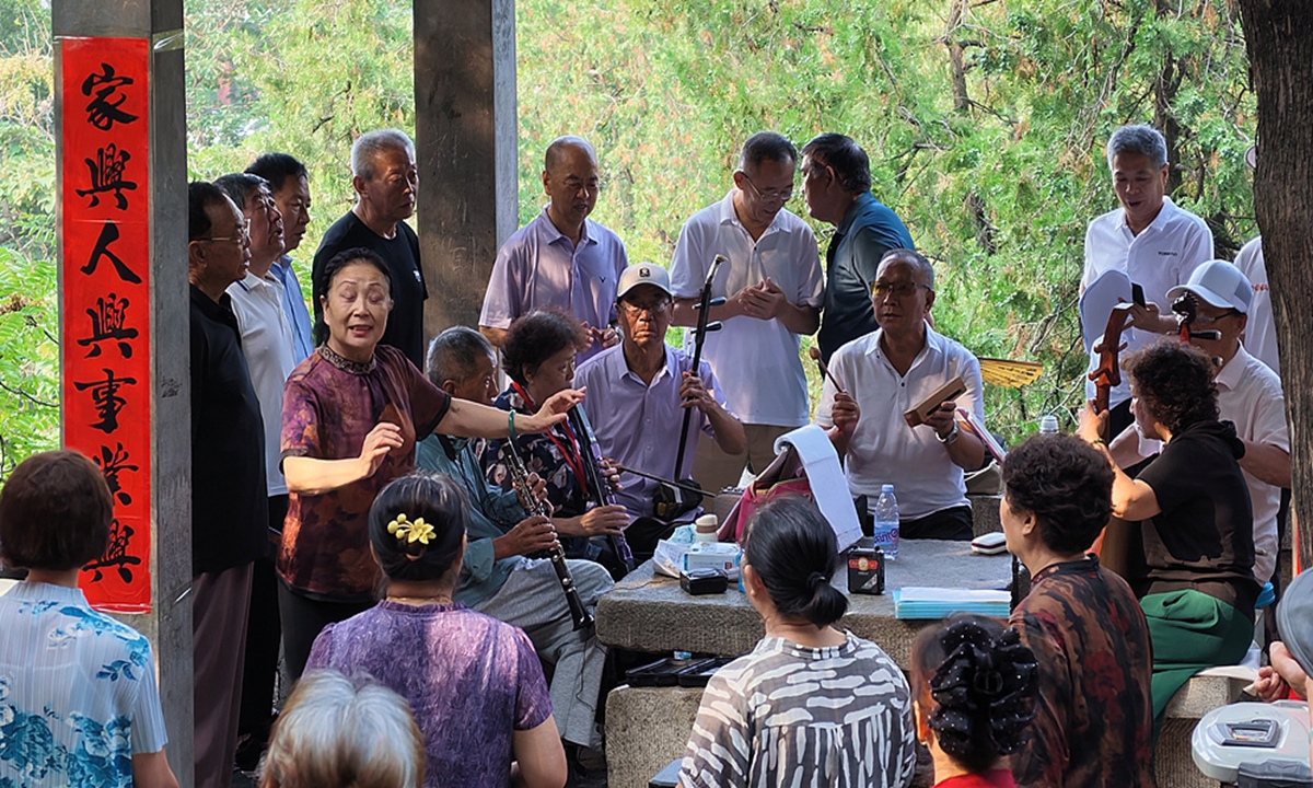 A group of elderly residents perform a collective chorus in a park in Tai'an, Shandong province, on July 20, 2026. Photo: VCG
