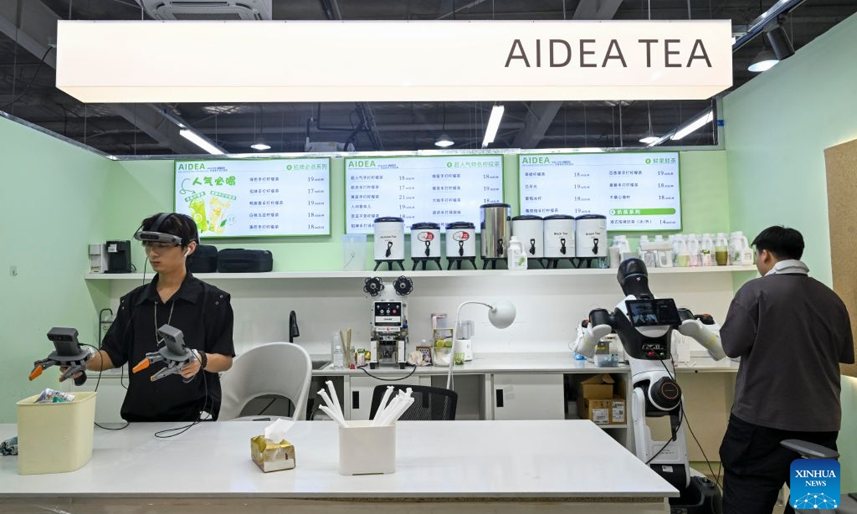 Staff members train a robot to work in a retail scenario at Maniformer, a physical AI data service platform, in Shanghai, east China, Aug. 5, 2026. In Shanghai's tech companies like AGIBOT and Maniformer, embodied intelligence robots are trained in household, retail, sorting, production and other real-world scenarios, to advance their AI capabilities for real-life use. (Xinhua/Chen Haoming)
