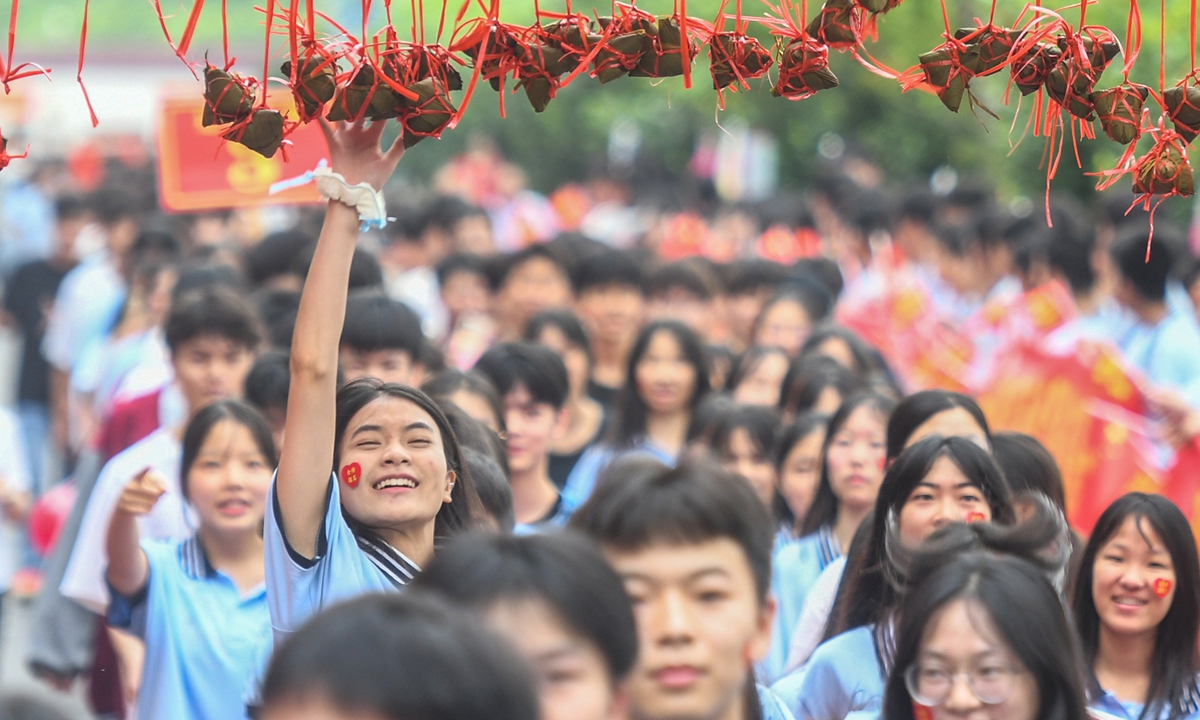 A student touches zongzi, symbolizing 