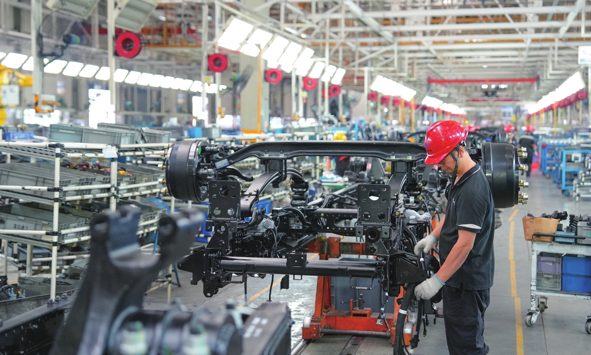 Workers assemble new-energy heavy-duty trucks at a production facility in Maanshan, East China's Anhui Province, on August 13, 2026. China's new-energy vehicle sales in July accounted for more than 60 percent of monthly new car sales for the first time, according to data from the China Association of Automobile Manufacturers. Photo: VCG