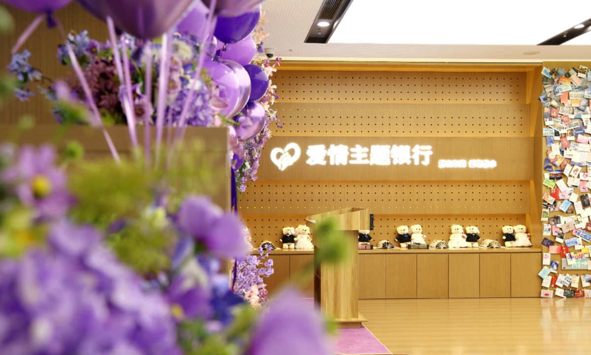An inside view of the bank hall, decorated for marriage registration with balloons, flowers and a ceremonial oath podium. Photo: CCTV News