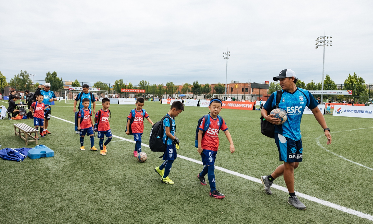 A coach walks his young players to the pitch for a soccer tournament in Beijing. Photo: Li Hao/GT
