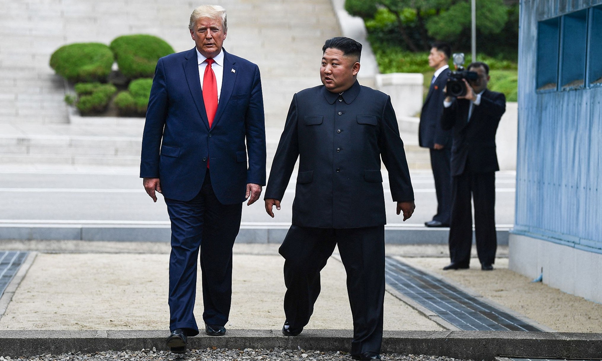 North Korea's leader Kim Jong Un and US President Donald Trump cross south of the Military Demarcation Line, after Trump briefly stepped over to the northern side, in the Joint Security Area (JSA) of Panmunjom in the Demilitarized zone (DMZ) on June 30, 2019. Photo: VCG