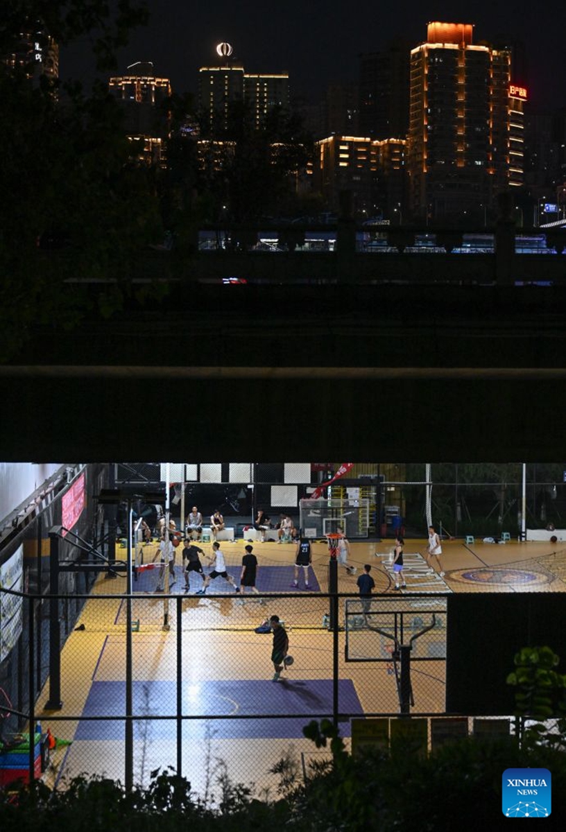 Residents play basketball under a bridge in Liangjiang New Area, southwest China's Chongqing, Aug. 12, 2026. In recent years, Liangjiang New Area has transformed vacant spaces under bridges into spaces for exercise and recreation. Photo: Xinhua
