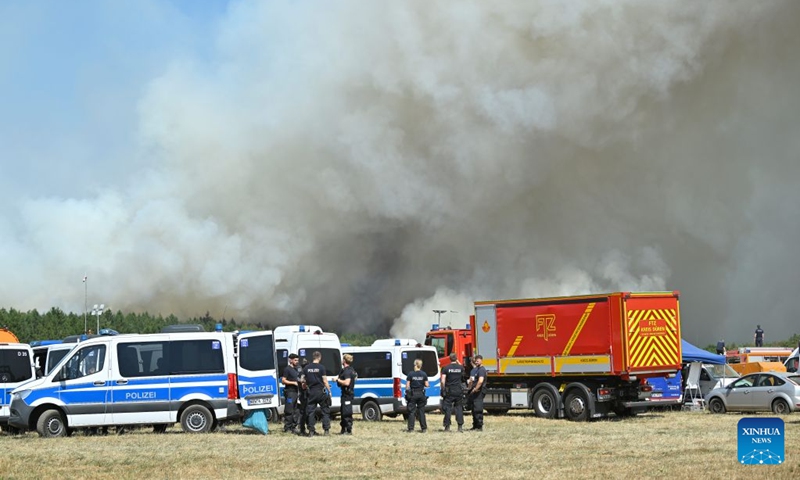 Police officers work near the site of a wildfire in Gey, Germany, Aug. 14, 2026. According to German media reports, a wildfire broke out in North Rhine-Westphalia, and over 2,000 residents were evacuated as a precaution for safety reasons. (Photo by Ulrich Hufnagel/Xinhua)