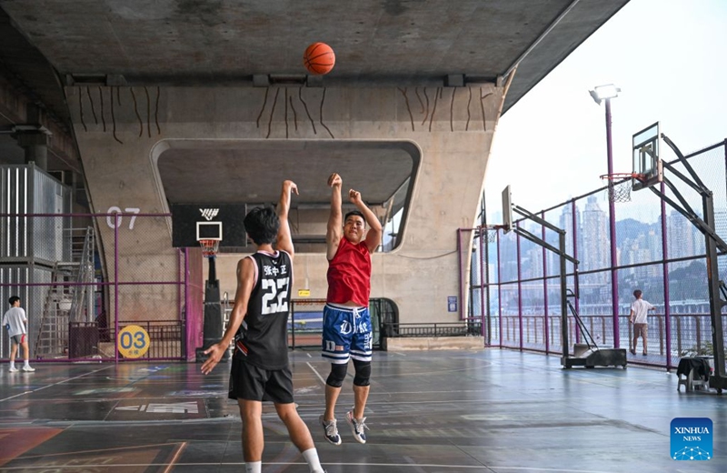 Residents play basketball under a bridge in Liangjiang New Area, southwest China's Chongqing, Aug. 10, 2026. In recent years, Liangjiang New Area has transformed vacant spaces under bridges into spaces for exercise and recreation. Photo: Xinhua
