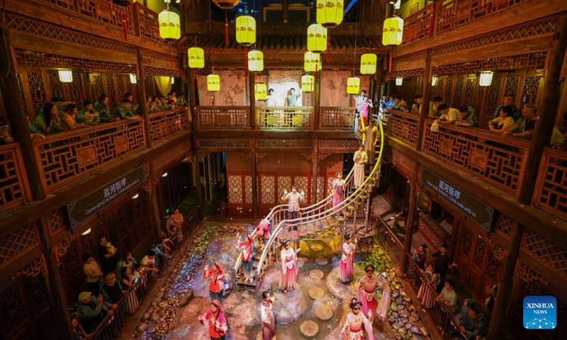Audience watch Changde Memories, a large-scale immersive performance, at Hejie leisure district in Changde, central China's Hunan Province, on Aug. 13, 2026. Hejie is a riverside leisure district combining tourism, recreation, vacation experience and residential use. Since 2025, the district has launched Changde Memories, a large-scale immersive site-specific performance featuring light shows, the history of river transport, and stories of local intangible cultural heritage. To date, the performance has attracted more than 50,000 visits, helping boost local spending. Photo: Xinhua