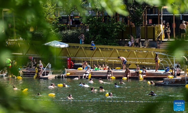People swim in the Seine River during a heatwave in Paris, France, Aug. 14, 2026. (Xinhua/Wu Huiwo)