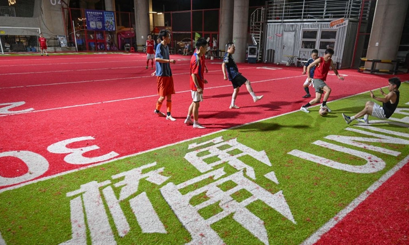 Residents play soccer under a bridge in Liangjiang New Area, southwest China's Chongqing, Aug. 13, 2026. In recent years, Liangjiang New Area has transformed vacant spaces under bridges into spaces for exercise and recreation. Photo: Xinhua