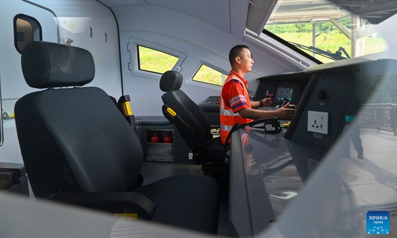 A staff member runs tests aboard a train at the Gombak station of the East Coast Rail Link (ECRL) in Selangor state, Malaysia, Aug. 14, 2026. The East Coast Rail Link (ECRL), a mega rail project in Malaysia being built by the China Communications Construction Company (CCCC), is expected to begin commercial operations by January 2027, Transport Minister Anthony Loke Siew Fook said on Friday. In the meantime, the railway has reached 95.08 percent overall progress and has entered its testing and commissioning phase, keeping with its project schedule, Loke said in his speech at the launch ceremony of the ECRL Comprehensive Inspection Train (CIT). Photo: Xinhua