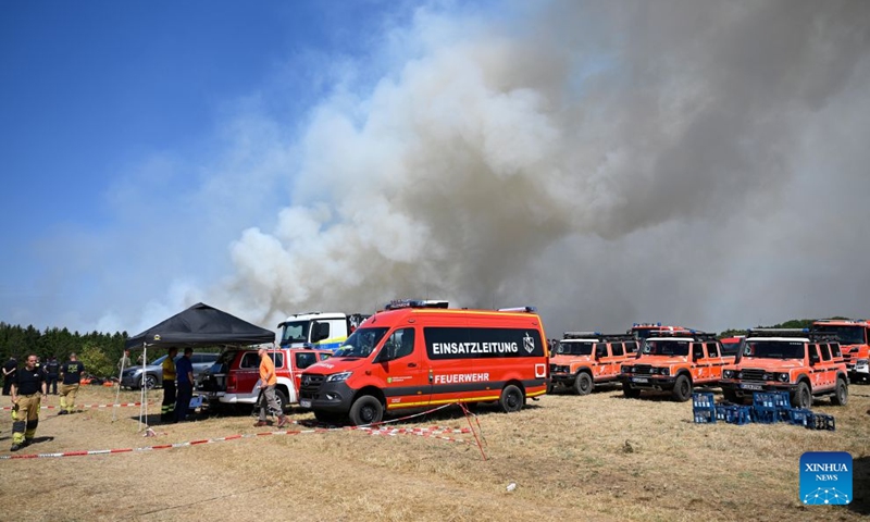 Firefighters work near the site of a wildfire in Gey, Germany, Aug. 14, 2026. According to German media reports, a wildfire broke out in North Rhine-Westphalia, and over 2,000 residents were evacuated as a precaution for safety reasons. (Photo by Ulrich Hufnagel/Xinhua)