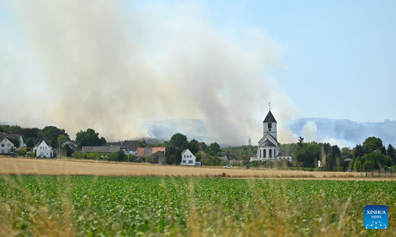 Smoke rises from a forest in Gey, Germany, Aug. 14, 2026. According to German media reports, a wildfire broke out in North Rhine-Westphalia, and over 2,000 residents were evacuated as a precaution for safety reasons. (Photo by Ulrich Hufnagel/Xinhua)