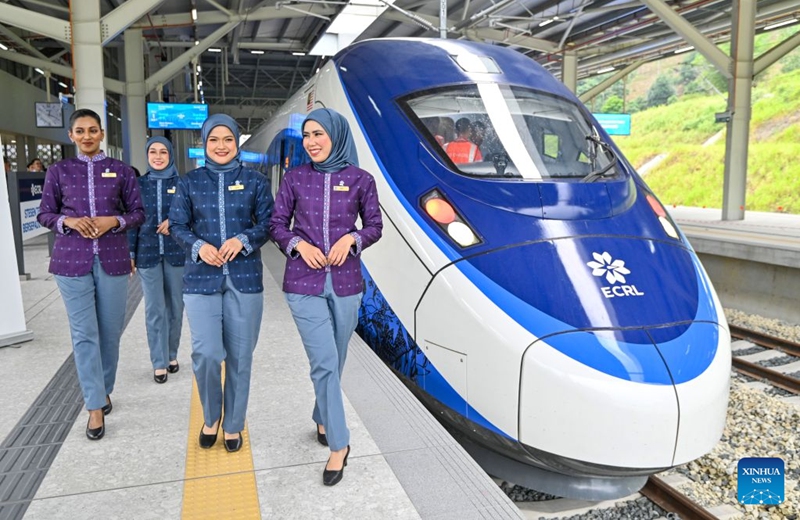 Train attendants walk past a train at the Gombak station of the East Coast Rail Link (ECRL) in Selangor state, Malaysia, Aug. 14, 2026. The East Coast Rail Link (ECRL), a mega rail project in Malaysia being built by the China Communications Construction Company (CCCC), is expected to begin commercial operations by January 2027, Transport Minister Anthony Loke Siew Fook said on Friday.
In the meantime, the railway has reached 95.08 percent overall progress and has entered its testing and commissioning phase, keeping with its project schedule, Loke said in his speech at the launch ceremony of the ECRL Comprehensive Inspection Train (CIT). Photo: Xinhua