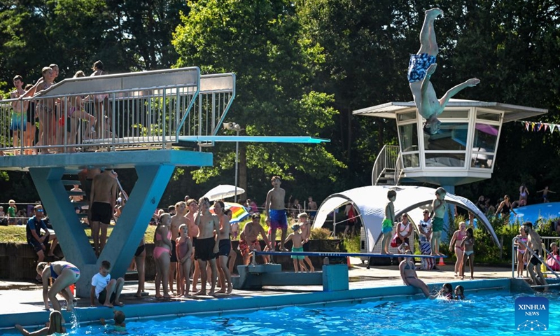 A man jumps into an outdoor swimming pool in Delden, the Netherlands, Aug. 14, 2026. The Royal Netherlands Meteorological Institute (KNMI) issued a yellow heat warning on Aug. 14, 2026, as temperatures reached 35 degrees Celsius, marking the fifth heatwave in the Netherlands this year. (Photo by Eric Brinkhorst/Xinhua)