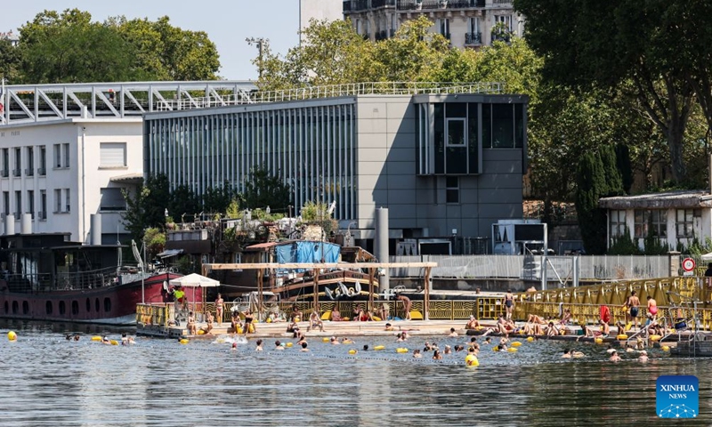 People swim in the Seine River during a heatwave in Paris, France, Aug. 14, 2026. (Xinhua/Wu Huiwo)