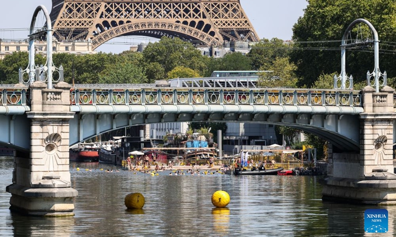 People swim in the Seine River during a heatwave in Paris, France, Aug. 14, 2026. (Xinhua/Wu Huiwo)