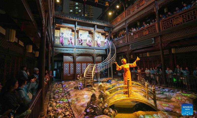 Audience watch Changde Memories, a large-scale immersive performance, at Hejie leisure district in Changde, central China's Hunan Province, on Aug. 13, 2026. Hejie is a riverside leisure district combining tourism, recreation, vacation experience and residential use. Since 2025, the district has launched Changde Memories, a large-scale immersive site-specific performance featuring light shows, the history of river transport, and stories of local intangible cultural heritage. To date, the performance has attracted more than 50,000 visits, helping boost local spending. Photo: Xinhua