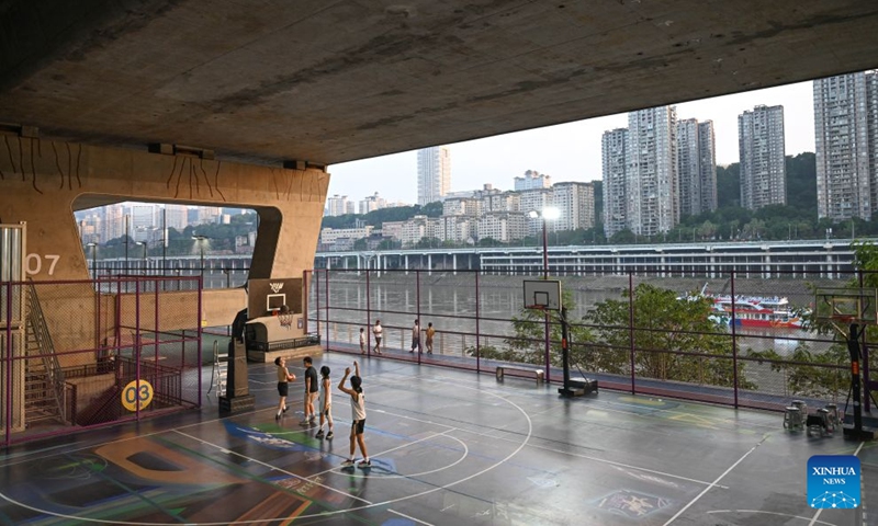 Residents play basketball under a bridge in Liangjiang New Area, southwest China's Chongqing, Aug. 10, 2026. In recent years, Liangjiang New Area has transformed vacant spaces under bridges into spaces for exercise and recreation. Photo: Xinhua