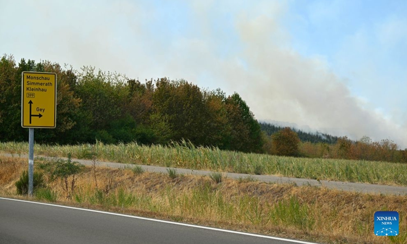 Smoke rises from a forest in Gey, Germany, Aug. 14, 2026. According to German media reports, a wildfire broke out in North Rhine-Westphalia, and over 2,000 residents were evacuated as a precaution for safety reasons. (Photo by Ulrich Hufnagel/Xinhua)