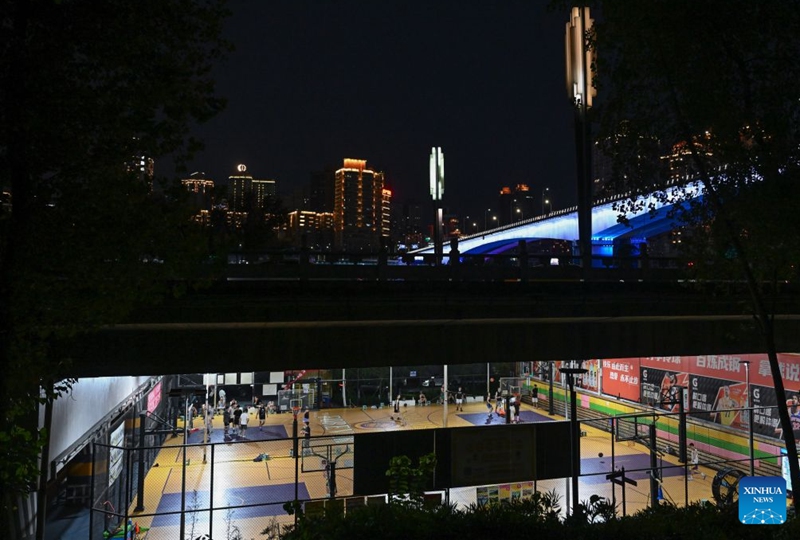 Residents play basketball under a bridge in Liangjiang New Area, southwest China's Chongqing, Aug. 12, 2026. In recent years, Liangjiang New Area has transformed vacant spaces under bridges into spaces for exercise and recreation. Photo: Xinhua