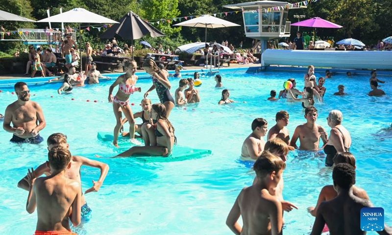 People cool off in an outdoor swimming pool in Delden, the Netherlands, Aug. 14, 2026. The Royal Netherlands Meteorological Institute (KNMI) issued a yellow heat warning on Aug. 14, 2026, as temperatures reached 35 degrees Celsius, marking the fifth heatwave in the Netherlands this year. (Photo by Eric Brinkhorst/Xinhua)