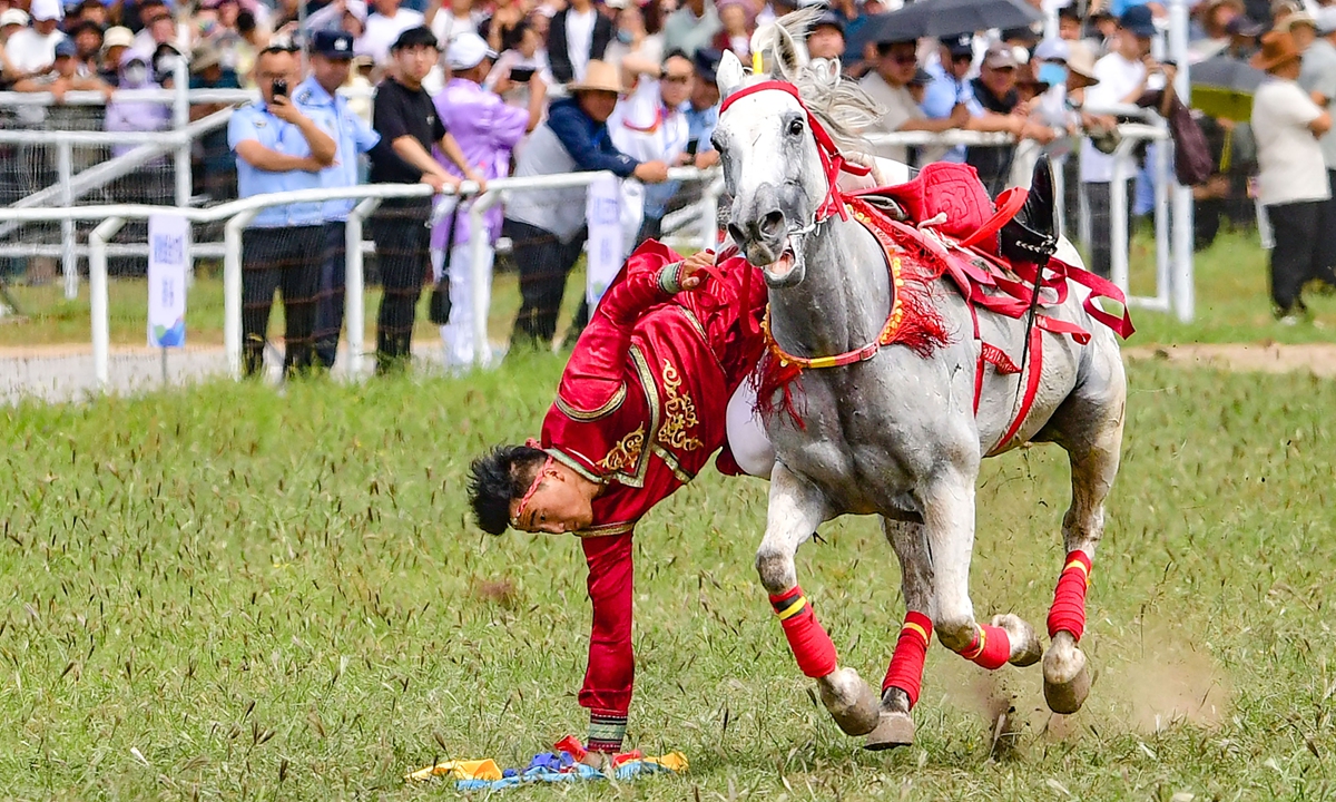 A performer takes part in a horse stunt show during the opening ceremony of the Nadam Fair in the Jalaid Banner, Hinggan League, North China's Inner Mongolia Autonomous Region, on August 16, 2026. The event features equestrian performances, singing, dancing, traditional music and folk displays. Photo: VCG
