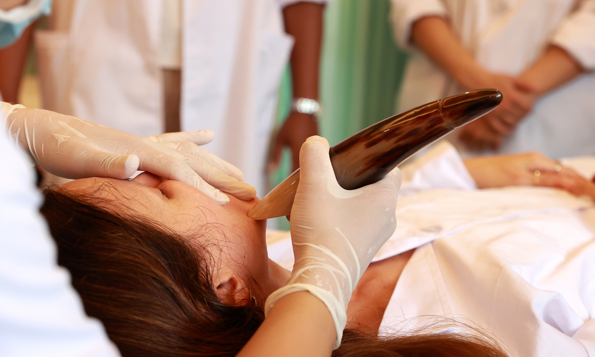 Trainees observe traditional Chinese medicine beauty techniques at the Sanya Hospital of Traditional Chinese Medicine in Sanya, South China's Hainan Province, on August 6, 2026.
