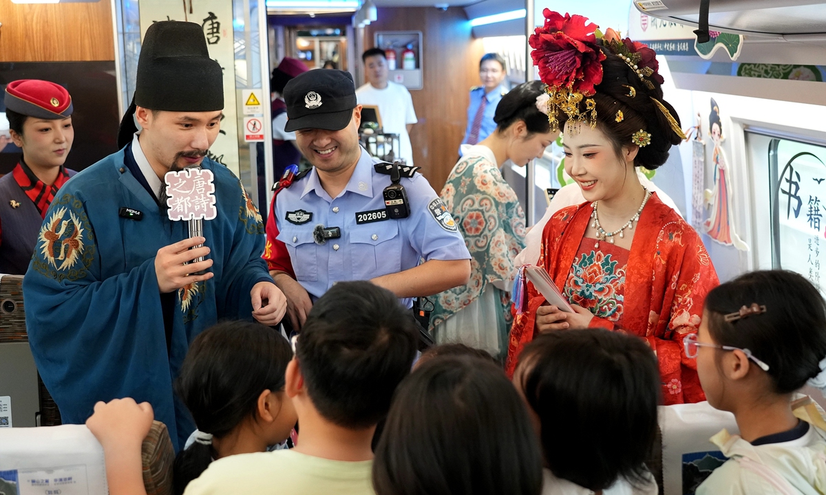 Ahead of the Qixi Festival, which falls on August 19 this year, railway staff members invite children to match lines from Tang poetry aboard a high-speed train from Xi'an, Northwest China's Shaanxi Province to Shanghai on August 18, 2026. Xi'an served as the capital in Tang Dynasty (618-907). Photo: VCG