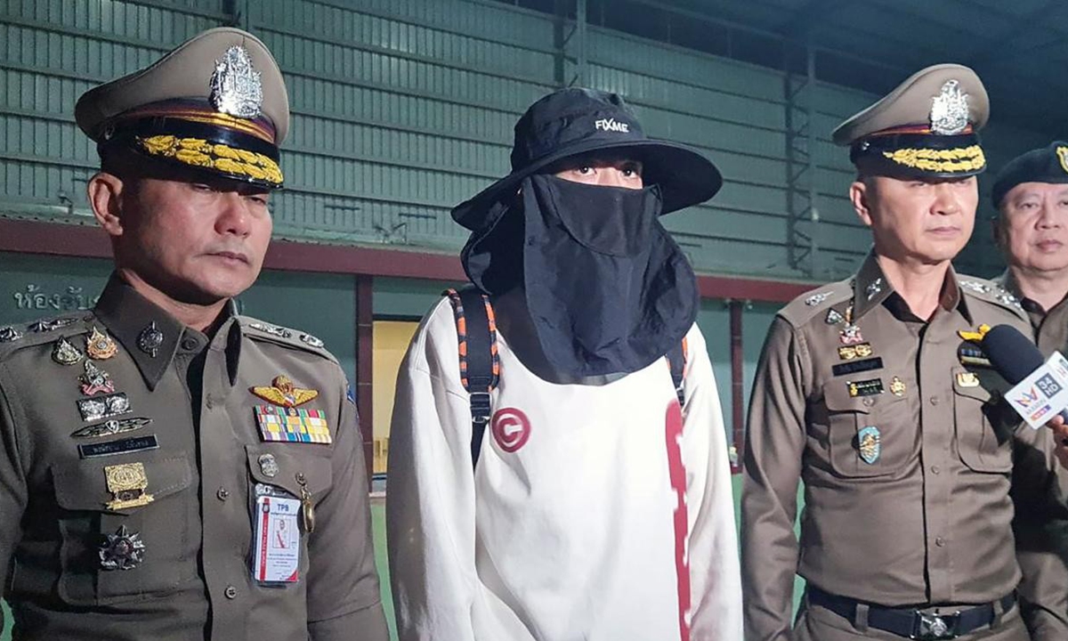 Chinese actor Wang Xing (center) is escorted by Thai police officers after returning from Myanmar, at the police airport in Bangkok, Thailand on January 7, 2025. 