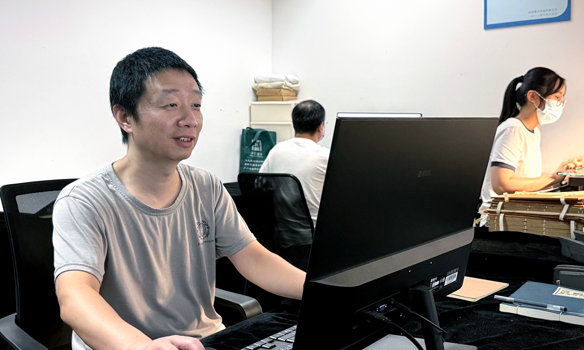 Huang Gang, director of the information technology department of Tianyige Museum, works on the digitization of ancient books. Photo: Courtesy of Tianyige Museum