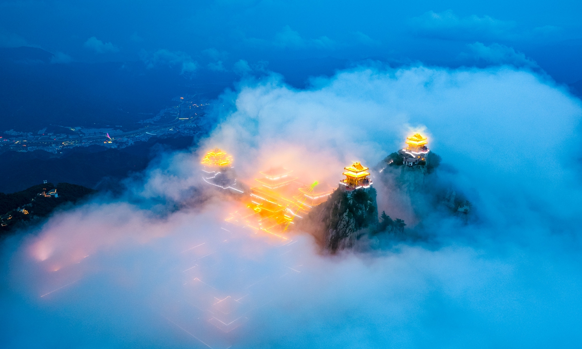 A sea of clouds rolls across Laojun Mountain in Luoyang, Central China's Henan Province, with golden-roofed temples emerging through the mist, on July 6, 2026. Photo: VCG