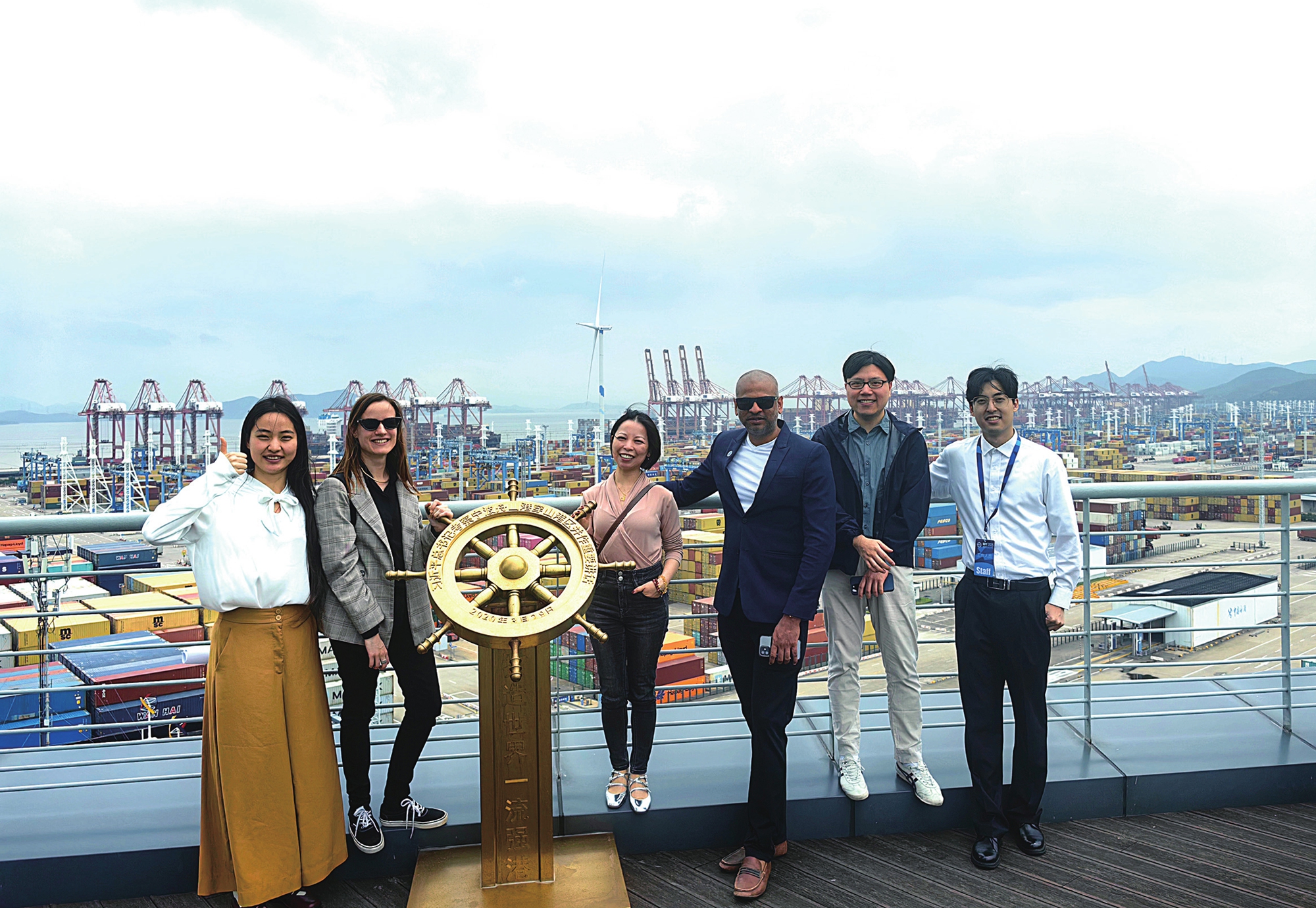 Foreign visitors take a group photo at Ningbo-Zhoushan Port. Photo: Courtesy of Ningbo-Zhoushan Port
