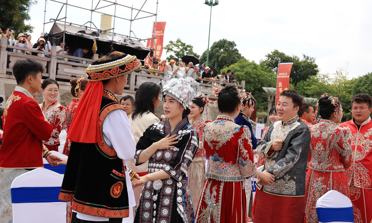 Twenty newlywed couples take part in a group wedding at a park in Qujing, Southwest China's Yunnan Province, on August 19, 2026 on the traditional Double Seventh Festival, the Chinese Valentine's Day. Photo: VCG