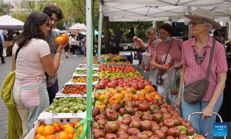 People shop at a farmers market in New York, the United States, on Aug. 21, 2026. (Xinhua/Zhang Fengguo)