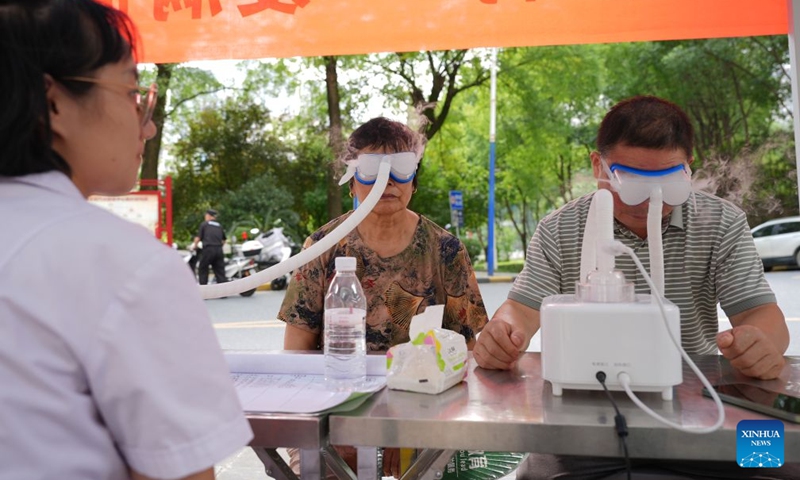 Residents receive eye therapy for health care at a community in Ankang City, northwest China's Shaanxi Province, Aug. 20, 2026. In recent years, Ankang has been actively exploring new models of community service management for groups such as the elderly and children. (Xinhua/Shao Rui)