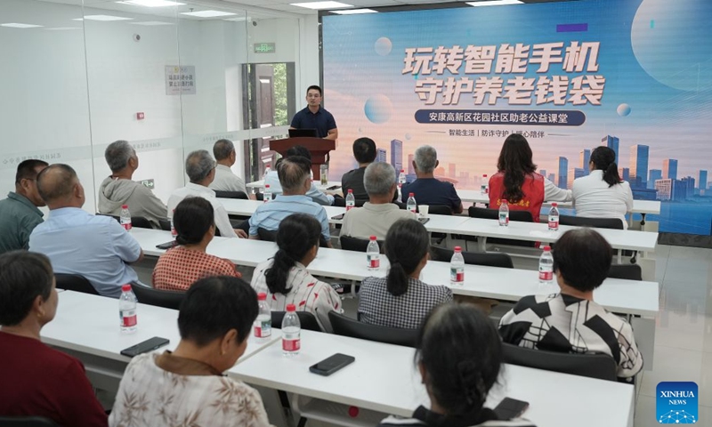 Senior residents attend an anti-fraud awareness lecture at a community in Ankang City, northwest China's Shaanxi Province, Aug. 20, 2026. In recent years, Ankang has been actively exploring new models of community service management for groups such as the elderly and children. (Xinhua/Shao Rui)