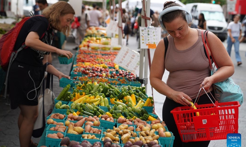 People shop at a farmers market in New York, the United States, on Aug. 21, 2026. (Xinhua/Zhang Fengguo)