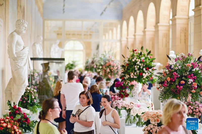 People visit the 42nd Royal Rose Exhibition at Royal Lazienki Park in Warsaw, Poland, on Aug. 21, 2026. The exhibition is held from Aug. 21 to 23 at Royal Lazienki Park, showcasing roses and floral arrangements from around the world. (Photo by Alexey Vitvitsky/Xinhua)