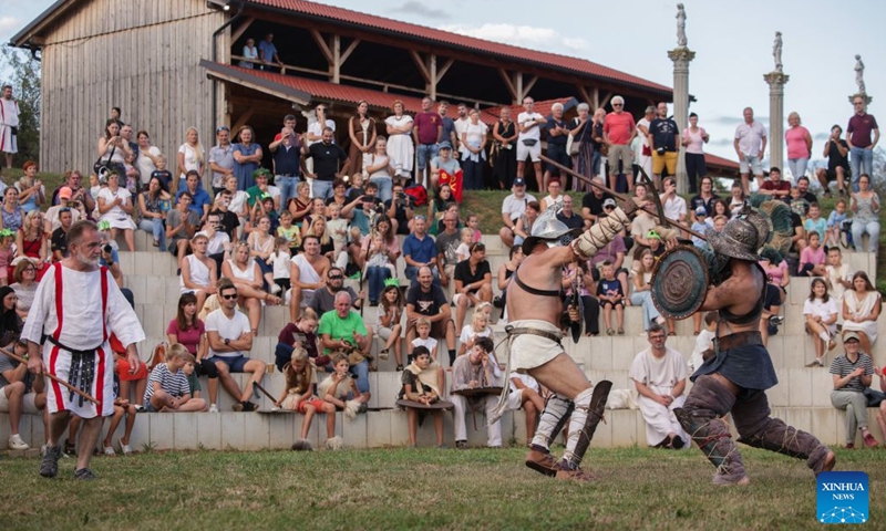 Participants dressed in gladiators demonstrate their battle skills during the Roman Games Festival in Ptuj, Slovenia, Aug. 22, 2026. The 19th edition of the Roman Games festival kicked off on Friday in Ptuj and will last till Aug. 23. (Photo by Zeljko Stevanic/Xinhua)