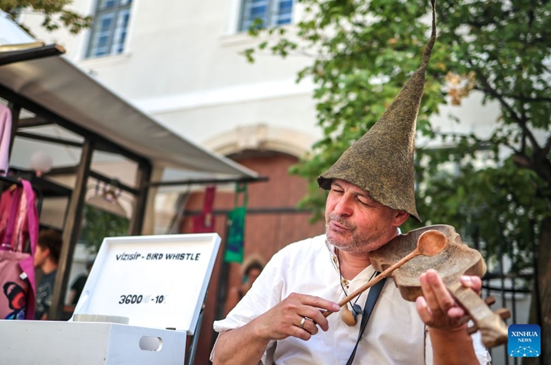 An artist performs during the Festival of Folk Arts at Buda Castle in Budapest, Hungary, Aug. 21, 2026. The annual festival showcases traditional Hungarian crafts and folk art as part of the celebration of Hungarian cultural heritage. (Photo by David Balogh/Xinhua)