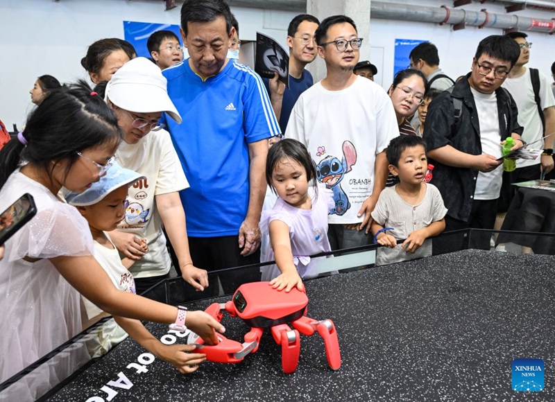 People view a crab-shaped robot at the 2026 World Robot Conference in Beijing, capital of China, Aug. 22, 2026. The conference, which runs from Wednesday through Sunday, has drawn more than 300 exhibitors from 26 countries, with over 3,000 products on display, including more than 300 debuts. Many people visited the conference on Saturday, the first open day of the event. Photo: Xinhua