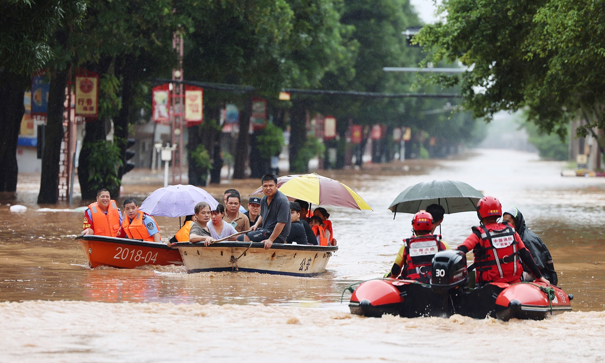 Rescue personnel use boats to evacuate residents to safety after flooding hit a town in Ningming county, South China's Guangxi Zhuang Autonomous Region, on August 23, 2026, following the impact of a typhoon. Photo: VCG
