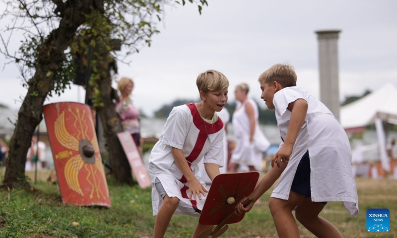Boys dressed in Roman costumes play during the Roman Games Festival in Ptuj, Slovenia, Aug. 22, 2026. The 19th edition of the Roman Games festival kicked off on Friday in Ptuj and will last till Aug. 23. (Photo by Zeljko Stevanic/Xinhua)