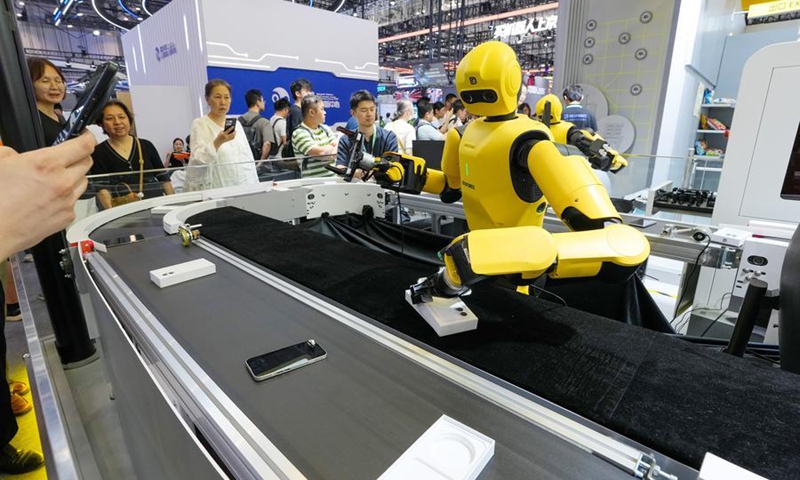 A robotic smartphone assembly and quality inspection line is displayed at the 2026 World Robot Conference (WRC) in Beijing, capital of China, Aug. 20, 2026. (Xinhua/Ju Huanzong)