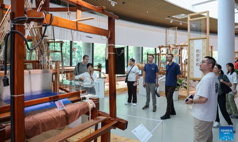 Members of a joint China-Russia media delegation visit the China National Silk Museum in Hangzhou, east China's Zhejiang Province, Aug. 20, 2026. The delegation visited Hangzhou from Aug. 20 to 22, experiencing the charm of Chinese culture. (Xinhua/Jiang Han)