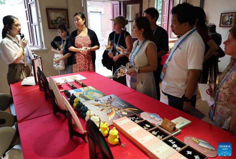 Delegates attending the Third APEC Senior Officials' Meeting and Related Meetings visit a historical and cultural neighborhood in Dalian, northeast China's Liaoning Province, Aug. 22, 2026. The Third APEC Senior Officials' Meeting and Related Meetings are held here from Aug. 17 to 28. (Xinhua/Li Gang)