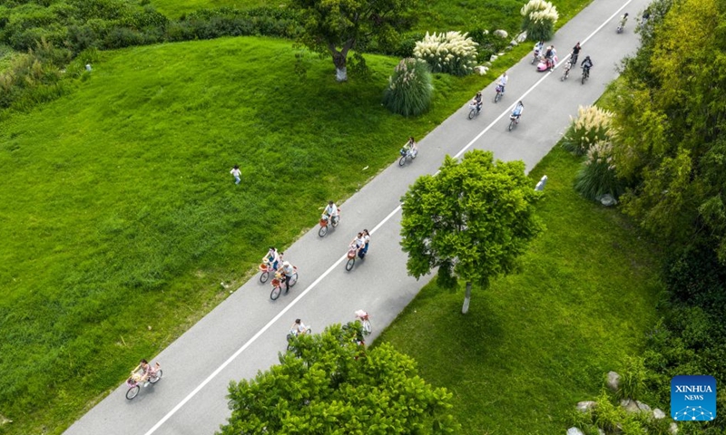 An aerial drone photo shows people cycling along the Erhai Lake ecological corridor in Dali, southwest China's Yunnan Province, Aug. 21, 2026. Photo: Xinhua